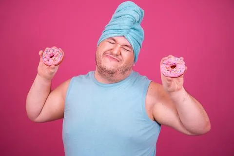 Funny fat man eats donuts. Retro style. Food and fitness. Stock Photos