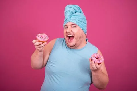 Funny fat man eats donuts. Retro style. Food and fitness. Stock Photos