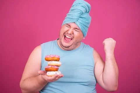Funny fat man eats donuts. Retro style. Food and fitness. 스톡 사진