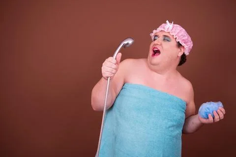 Funny fat man is washing himself in the shower. Stock Photos