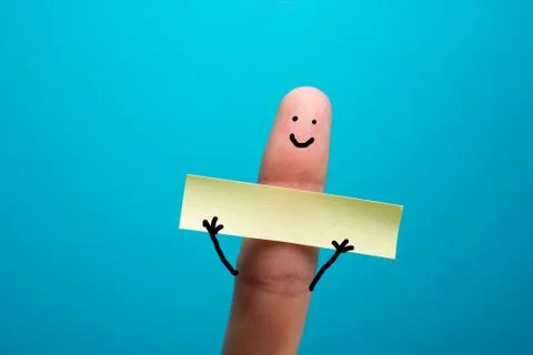 Funny finger holding blank bunner showing on it and smiling Stock Photos