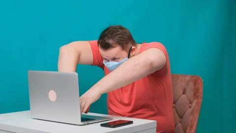 Funny frames of male using laptop. man working on a computer in a protective Stock Photos