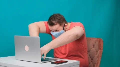 Funny frames of male using laptop. man working on a computer in a protective Stock Photos