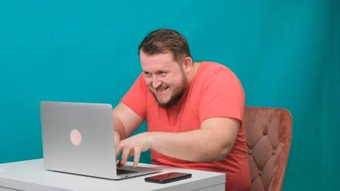 Funny frames of male using laptop. man working on a computer pretending to be a Stock Photos