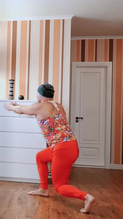 Funny freak. Fat man in multicolored T-shirt and red tight-fitting leggings, is Stock Footage 316891099