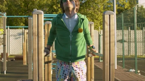 Funny freak man pushing up on parallel bars Stock Footage 133954896