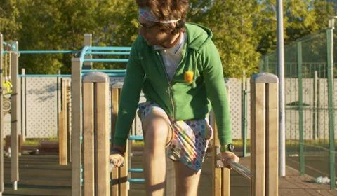 Funny freak man pushing up on parallel bars Stock Photos