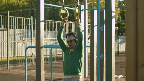Funny freak pulls up on the rings, but quickly gets tired Stock Footage 133953060