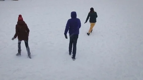 Funny friends playing in the snow on a bright winter day.Slow motion.Aerial shot Stock Footage 71505380