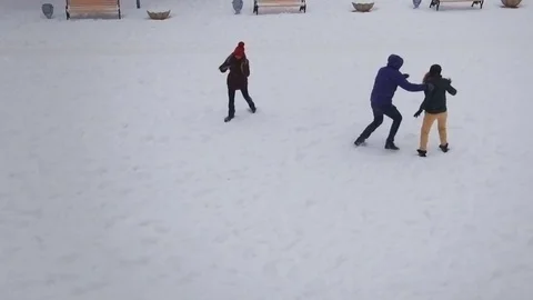 Funny friends playing in the snow on a bright winter day.Slow motion.Aerial shot Stock Footage 71505437