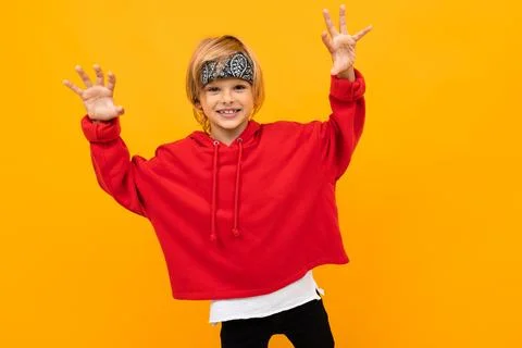 Funny funny guy in red clothes on a yellow background smiling Stock Photos
