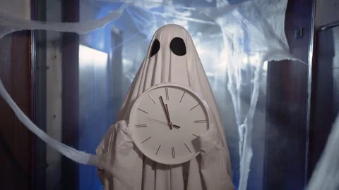 Funny ghost in white sheet standing in dark hallway with cobwebs and smoke Stock Footage 313555466