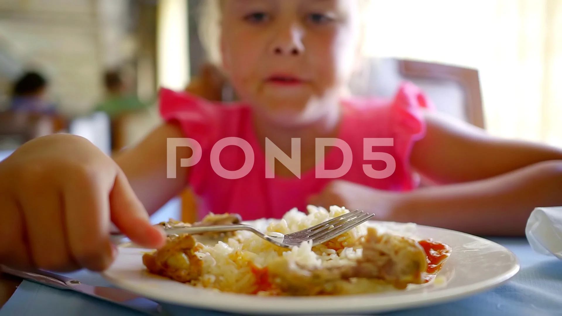 a funny girl eating rice with meat sitti... | Stock Video | Pond5