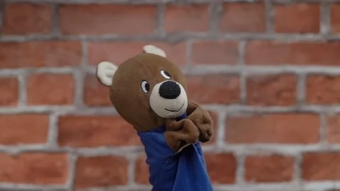 Funny glove bear over brick background Stock Footage 79058342