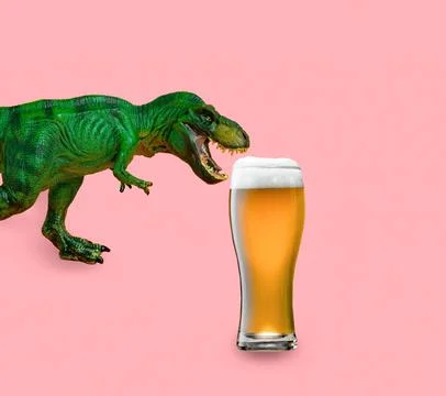 Funny green dinosaur with big beer glass on pink background. Creative minim.. Stock Photos