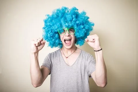 Funny guy with blue wig singing Stock Photos