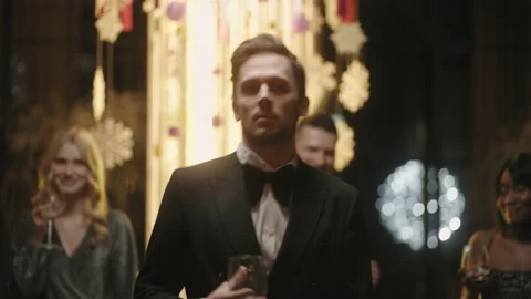 Funny guy is dancing in merry New year party, look at camera and flirting Stock Footage 229606931