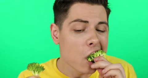 Funny guy eating broccoli. Video stock 160480390