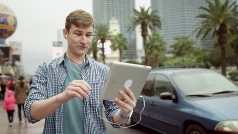 Funny guy is having a video chat on a street Stock Footage