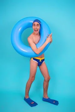 Funny guy with an inflatable ring in the pool. Stock Photos