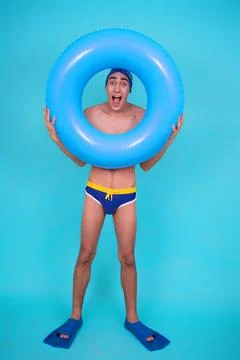 Funny guy with an inflatable ring in the pool. Stock Photos