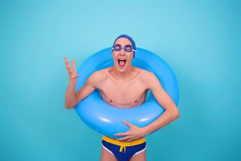Funny guy with an inflatable ring in the pool. Stock Photos