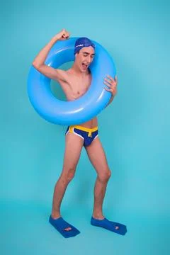 Funny guy with an inflatable ring in the pool. Stock Photos