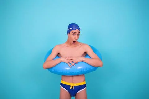 Funny guy with an inflatable ring in the pool. 스톡 사진