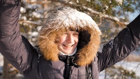Funny guy shakes a snowy tree branch on his head Stock Footage 114692029