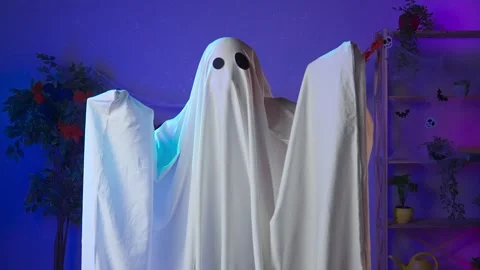 Funny halloween ghost in white sheet with black eyes in dark room standing Stock Footage 285741530