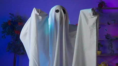 Funny halloween ghost in white sheet with black eyes in dark room standing Stock Footage 285741537