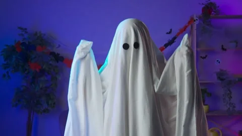 Funny halloween ghost in white sheet with black eyes in dark room dancing cool Stock Footage 285741948