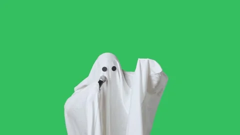 Funny halloween ghost in white sheet singing son in karaoke microphone, isolated Stock Footage 285748992