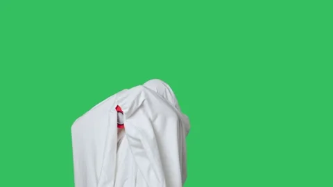 Funny halloween ghost in white sheet dancing with speaker on the shoulder Stock Footage 285750606