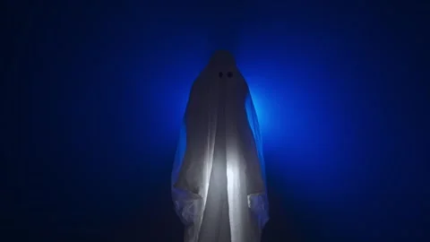 Funny halloween ghost in white sheet silhouette shines under sheet with 스톡 동영상 285751424