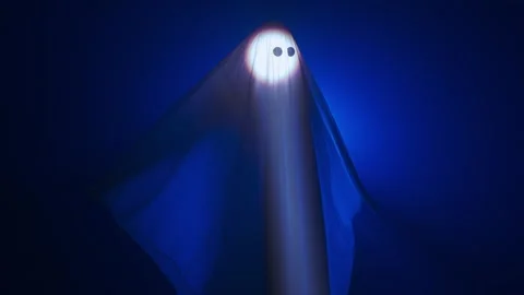 Funny halloween ghost in white sheet silhouette moving under ray of white light 스톡 동영상 285751793