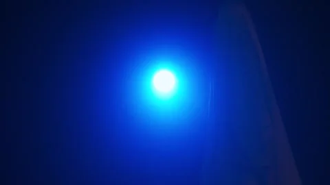 Funny halloween ghost in white sheet silhouette walking past bright blue Stock Footage 285753978