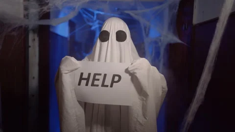Funny halloween ghost in white sheet showing inscription Help on blank. spooky Stock Footage 313669299