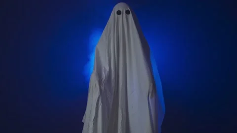 Funny halloween ghost in white sheetsilhouette creepy walking closer to camera Stock Footage 285753472