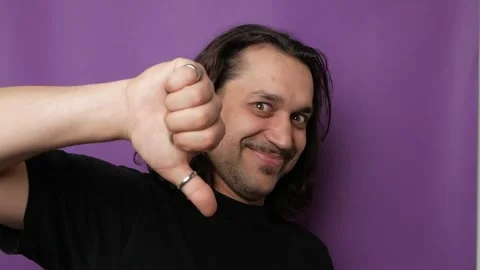 A funny, handsome guy shows indecent hand gestures. Stock Footage 250623473
