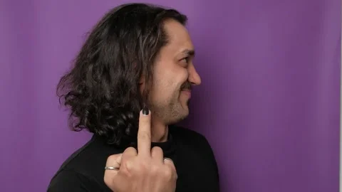 A funny, handsome guy shows indecent hand gestures. Video stock 250625184