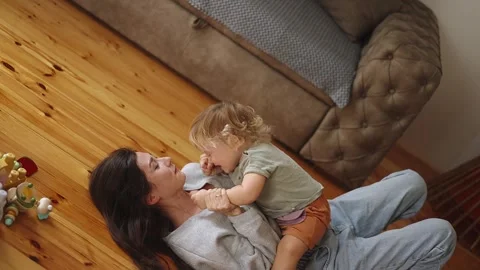 Funny happy cute boy playing and laughing having fun with young asian mother Stock Footage 240696209