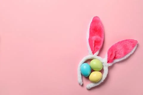 Funny headband with Easter bunny ears and dyed eggs on color background, flat Stock Photos