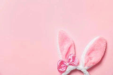 Funny headband with Easter bunny ears on color background, top view. Space fo 스톡 사진