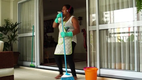 Funny Housekeeper Dancing and Having Fun With Broom Stock Footage 83390996