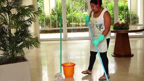 Funny Housekeeper Dancing and Having Fun With Broom Stock Footage 83391151