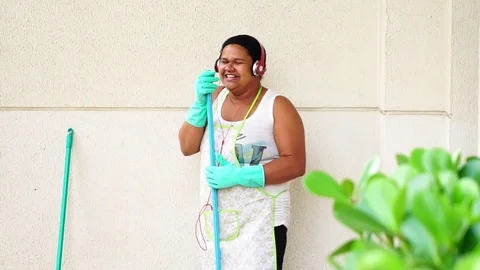 Funny Housekeeper Dancing and Having Fun With Broom Stock Footage 83391418