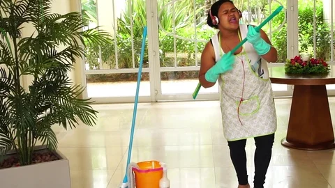 Funny Housekeeper Dancing and Having Fun With Broom Stock Footage 83391427