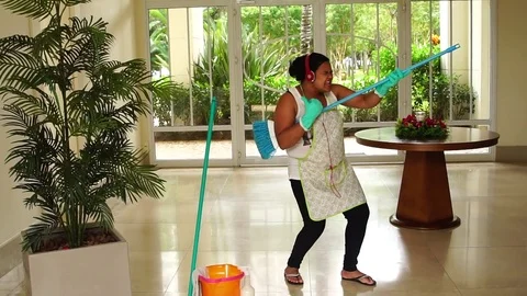 Funny Housekeeper Dancing and Having Fun With Broom Stock Footage 83391485
