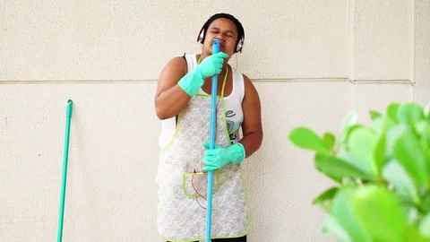 Funny Housekeeper Dancing and Having Fun With Broom Video stock 83391509